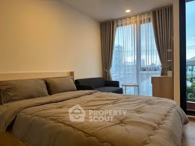 Modern bedroom with cozy bed and city view from large window