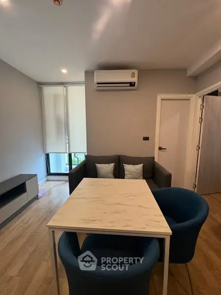 Modern living room with cozy seating and stylish decor in a contemporary apartment.