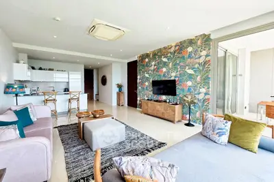 Spacious living room with modern decor and open kitchen layout
