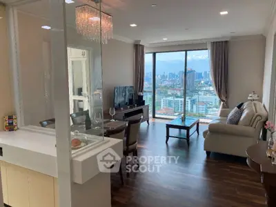 Luxurious living room with stunning city view, elegant furnishings, and floor-to-ceiling windows.