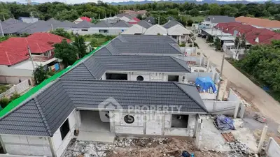 Newly constructed residential houses with modern roofing in a suburban neighborhood.