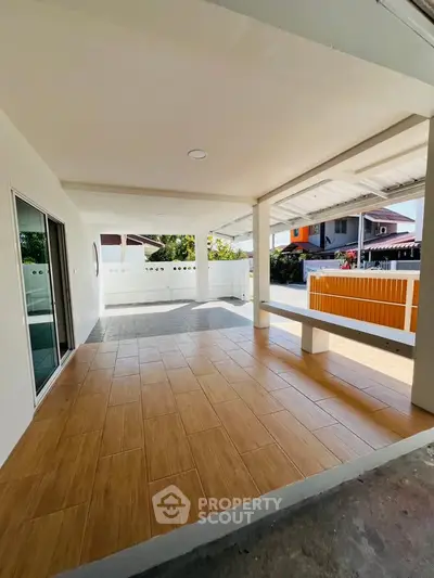 Spacious covered patio with modern design and wooden flooring