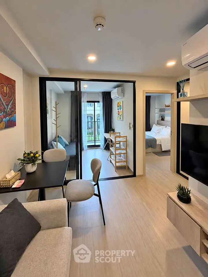 Modern open-plan living room with stylish decor and balcony view