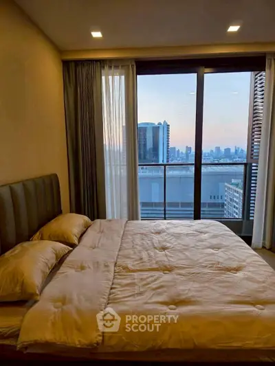 Luxurious bedroom with stunning city view from large window and cozy bedding.