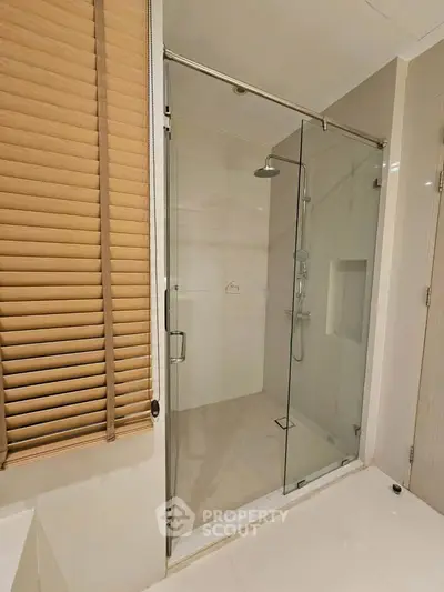 Modern bathroom with glass shower enclosure and sleek design