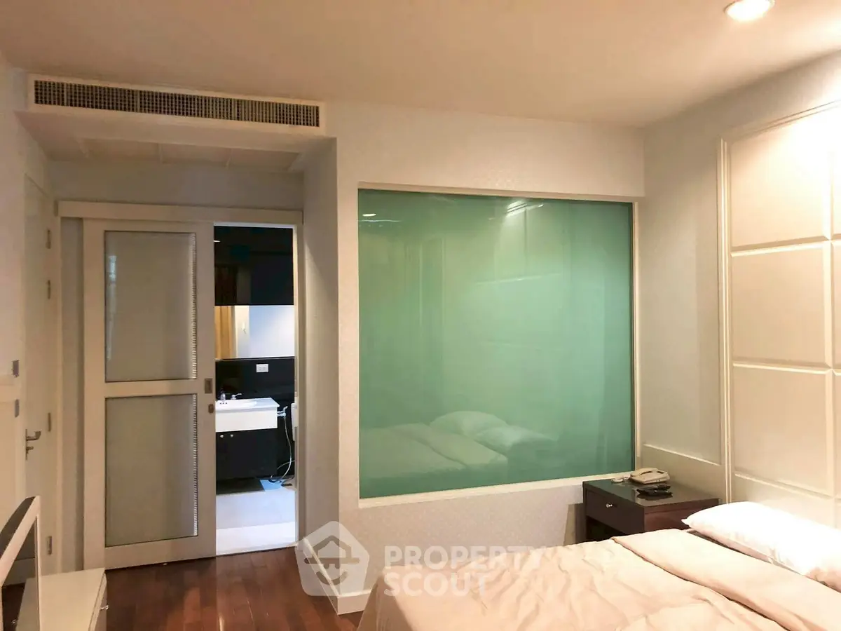 Modern bedroom with ensuite bathroom and stylish glass partition