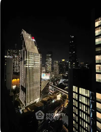 Stunning night view of illuminated city skyscrapers showcasing modern architecture and vibrant urban life.