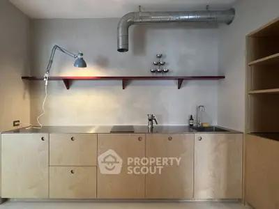 Modern minimalist kitchen with sleek cabinetry and industrial lighting