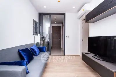 Modern living room with sleek design, featuring a comfortable sofa and large TV, perfect for relaxation.