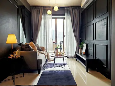 Stylish modern living room with elegant decor and large window view.