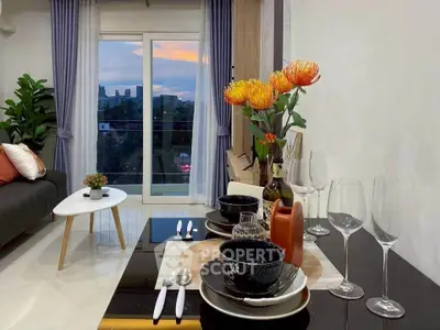 Stylish living room with elegant dining setup and city view balcony.