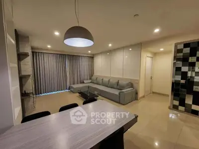 Spacious modern living room with elegant decor and ample natural light.