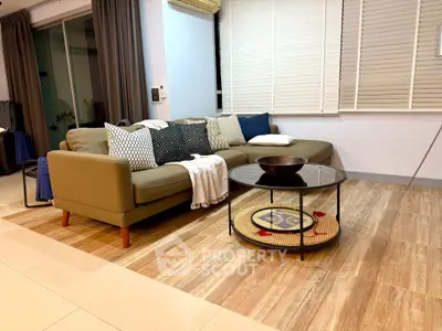 Stylish living room with modern sofa and chic decor in a cozy apartment.
