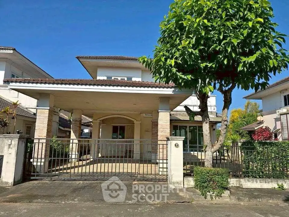 Charming two-story house with spacious driveway and lush greenery in a serene neighborhood.