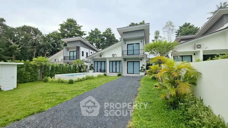 Modern villa with lush garden and private pool in serene setting