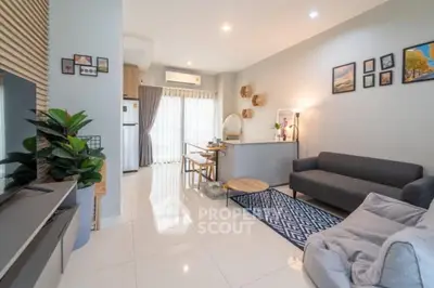 Modern living room with stylish decor and open layout, featuring a cozy sofa and natural light.