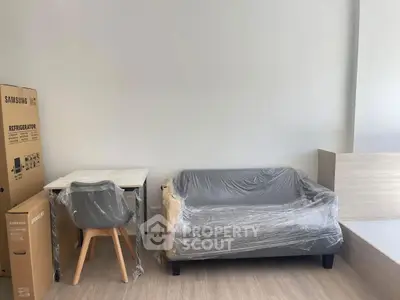 Modern apartment interior with wrapped furniture and Samsung refrigerator box