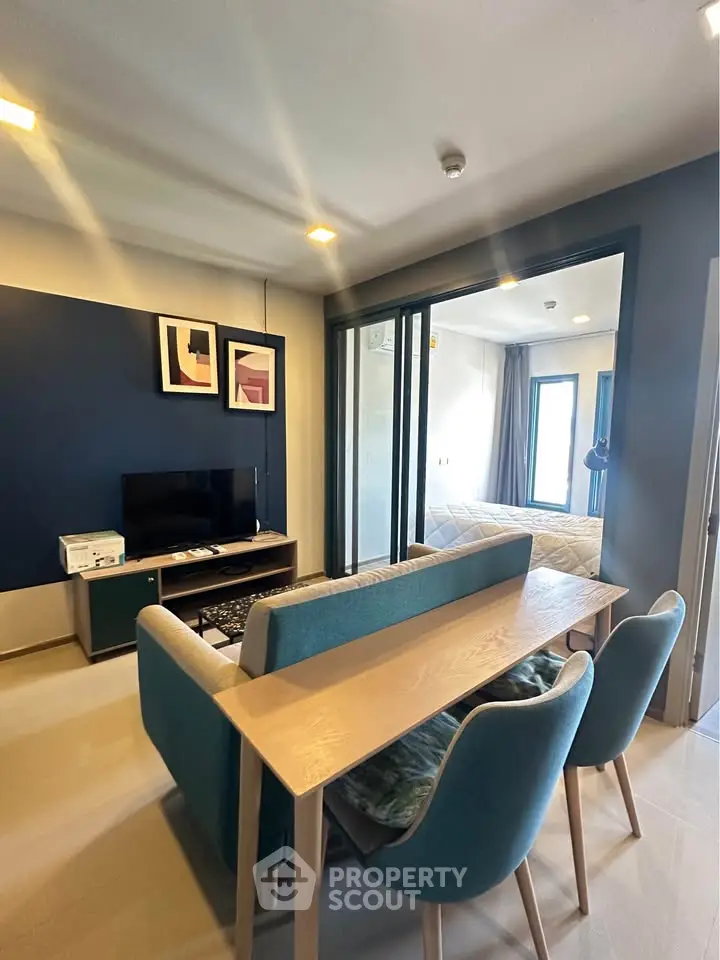 Modern living room with stylish decor and dining area in open layout apartment.