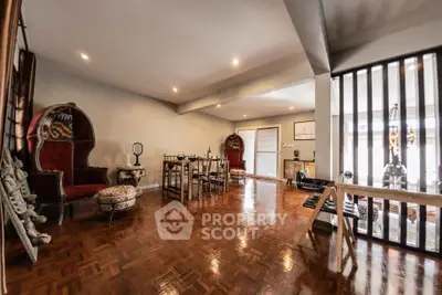 Spacious living room with elegant decor and polished wooden floors, perfect for entertaining guests.