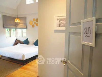 Inviting bedroom with cozy decor and natural light, perfect for relaxation.
