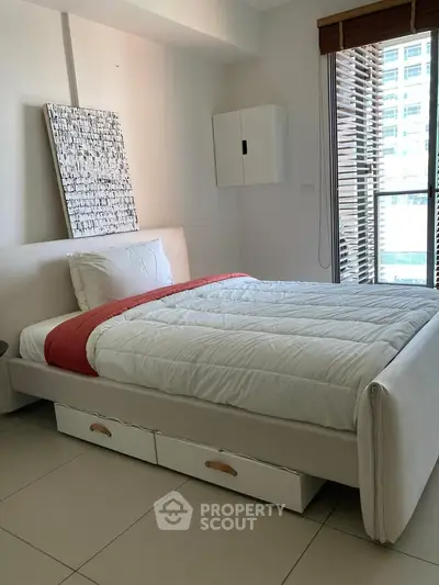 Modern bedroom with stylish decor and natural light in urban apartment