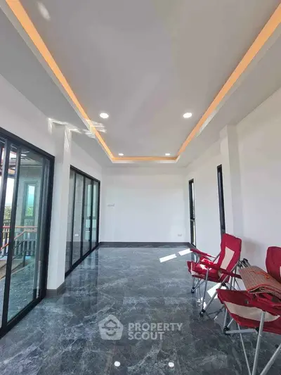 Spacious modern living room with sleek marble flooring and recessed lighting