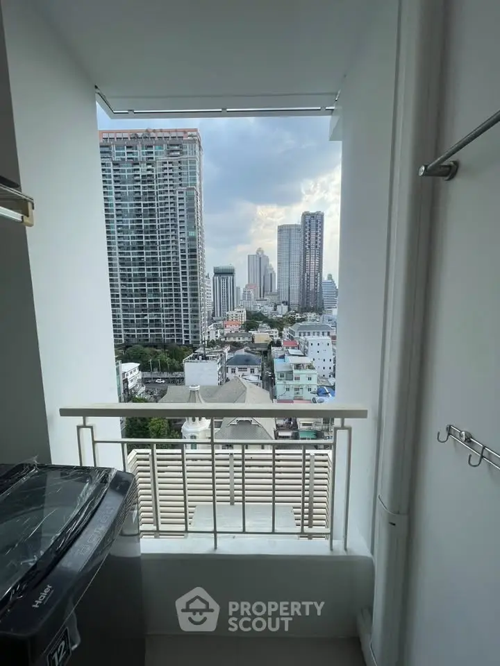 Stunning city view from a high-rise balcony with modern urban skyline.