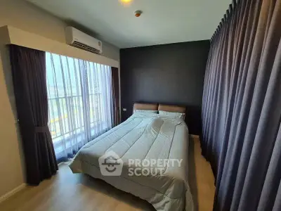 Modern bedroom with large window and elegant curtains in a stylish apartment.