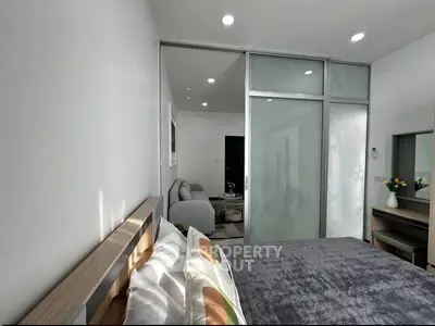 Modern bedroom with sliding glass doors and cozy decor