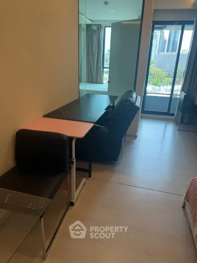 Modern apartment interior with glass partition and balcony view