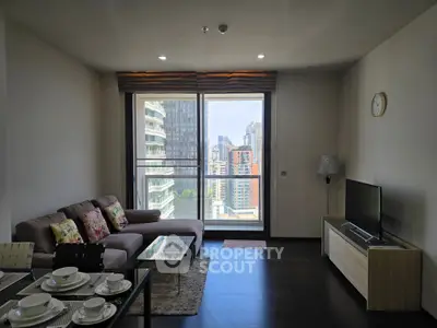 Modern living room with city view, stylish furniture, and elegant decor in a high-rise apartment.