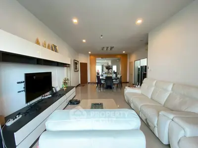 Spacious modern living room with sleek white furniture and open layout