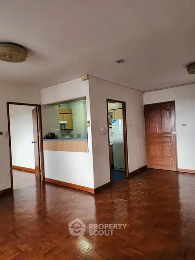 Spacious apartment with wooden flooring and open kitchen layout