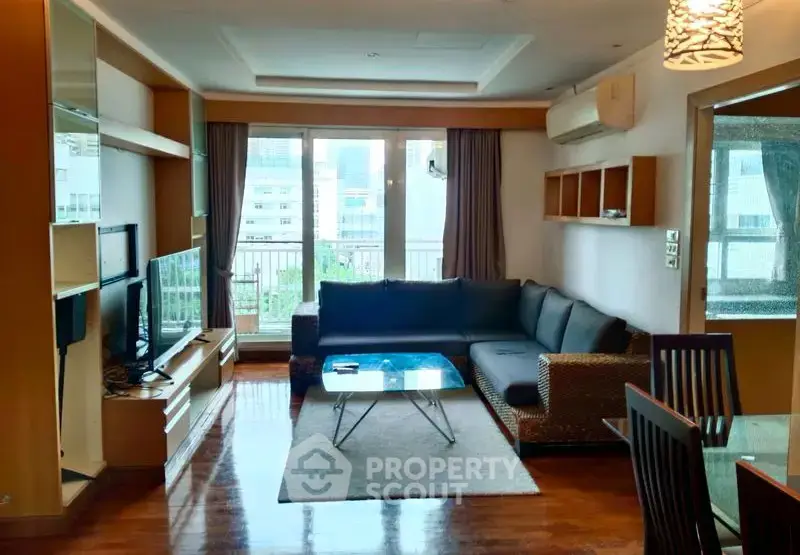 Spacious living room with modern furniture and large windows offering natural light.