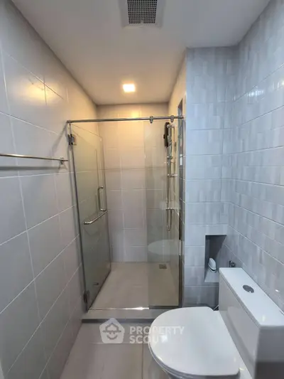 Modern bathroom with glass shower and sleek tile design