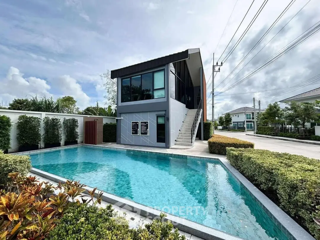 Modern two-story building with pool and lush landscaping
