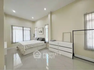 Spacious bedroom with modern furnishings and natural light