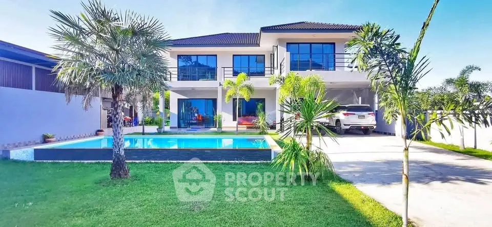 Luxurious modern villa with pool and lush garden, perfect for family living.