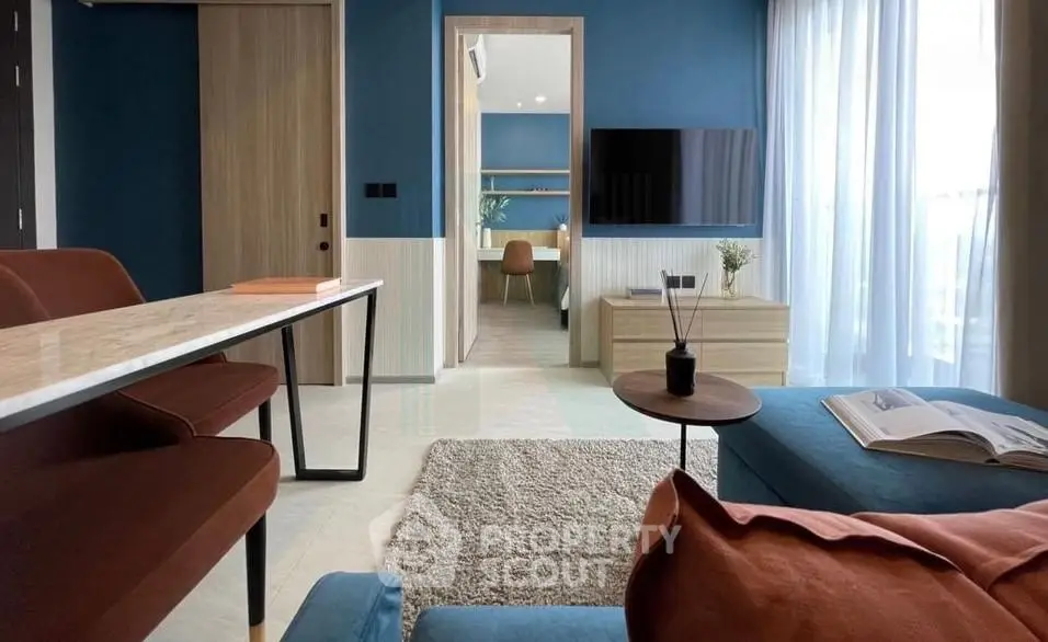 Modern living room with stylish furniture and open layout, featuring a cozy ambiance and elegant decor.