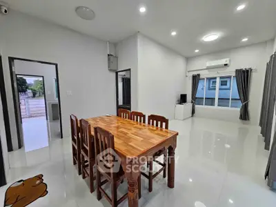 Spacious modern dining area with wooden table and chairs, bright lighting, and sleek tile flooring.