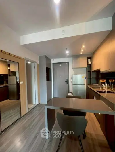 Modern kitchen with sleek design, featuring built-in appliances and stylish dining area.