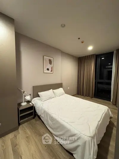 Modern bedroom with cozy bed and stylish decor in a contemporary apartment.