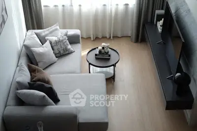 Modern living room with stylish gray sofa and sleek TV unit