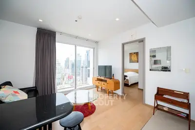 Modern living room with city view and stylish decor in high-rise apartment