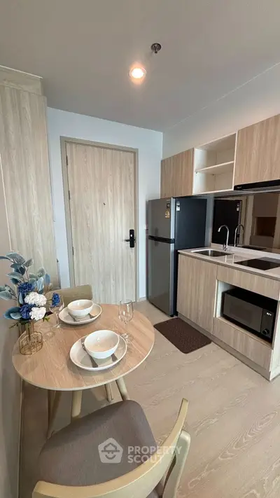 Modern compact kitchen with dining area and stylish decor