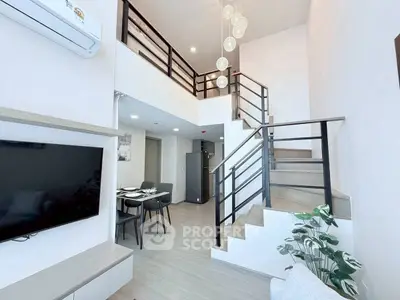 Modern duplex living room with stylish staircase and dining area