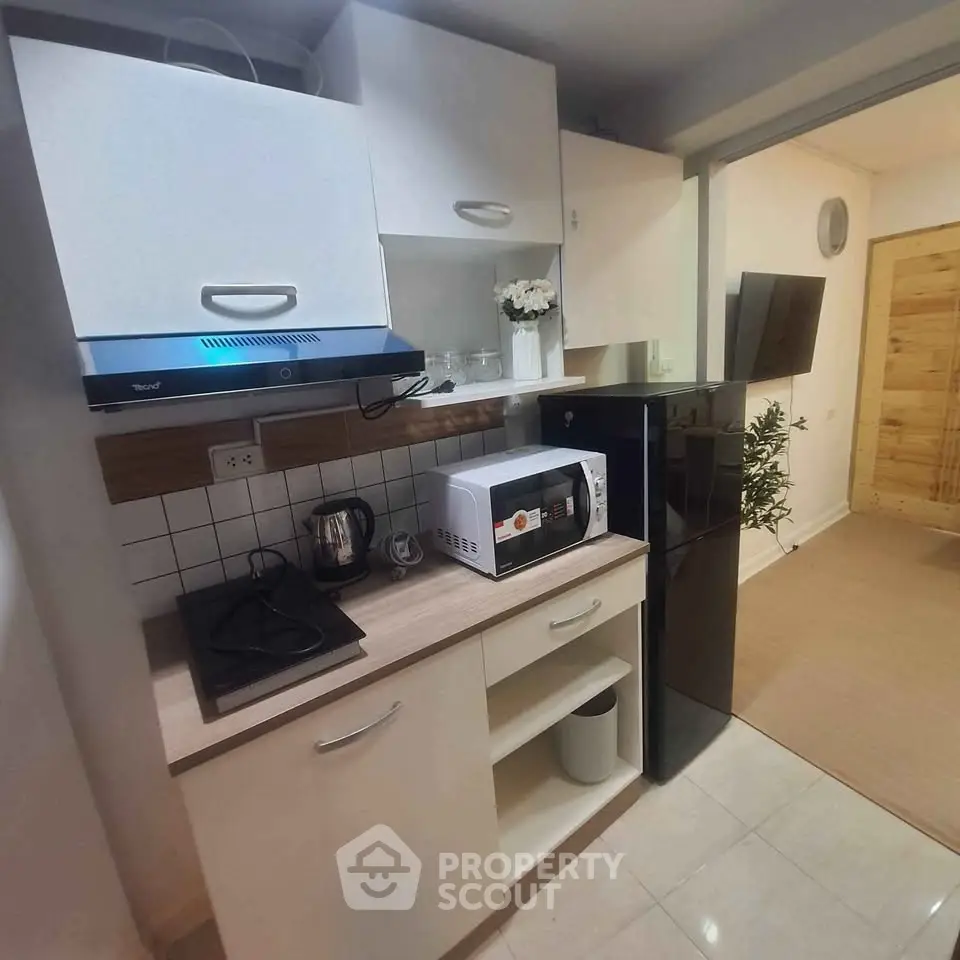 Modern compact kitchen with sleek appliances and stylish cabinetry