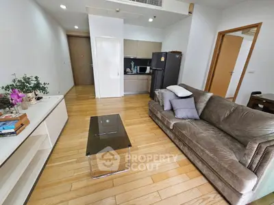 Modern living room with sleek furniture and open kitchen layout