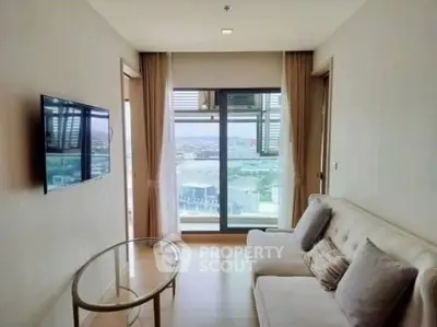 Modern living room with stunning city view, featuring a sleek TV and cozy sofa.