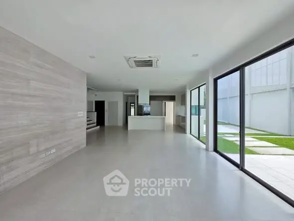 Spacious modern living area with open layout and large windows